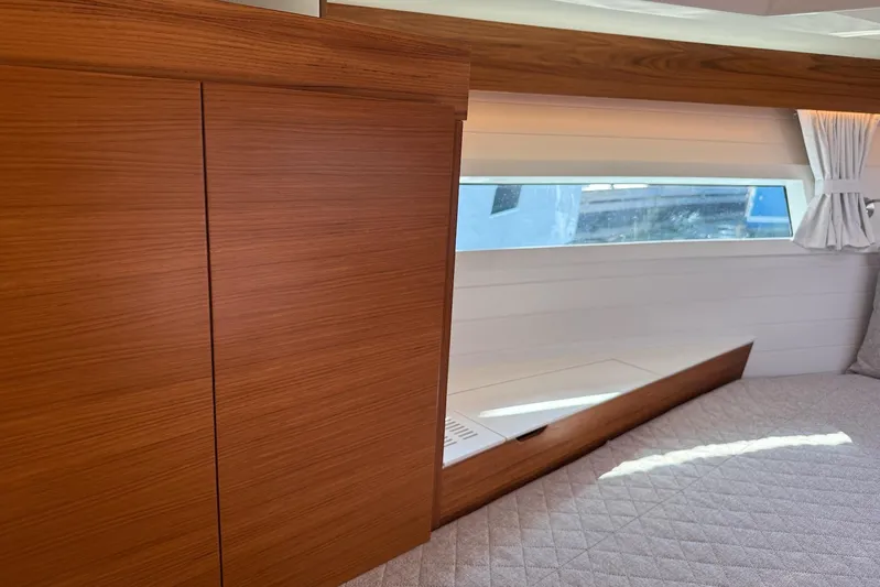  Yacht Photos Pics Luxurious interior of 2026 Delta Powerboats 48 Coupe with wood finish and window view.