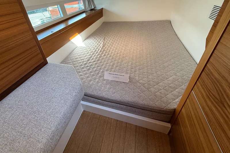  Yacht Photos Pics Cozy cabin interior of 2026 Delta Powerboats 48 Coupe with modern design and comfortable bedding.