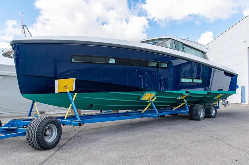  Yacht Photos Pics 2026 Delta Powerboats 48 Coupe on trailer, sleek design, blue and green hull.