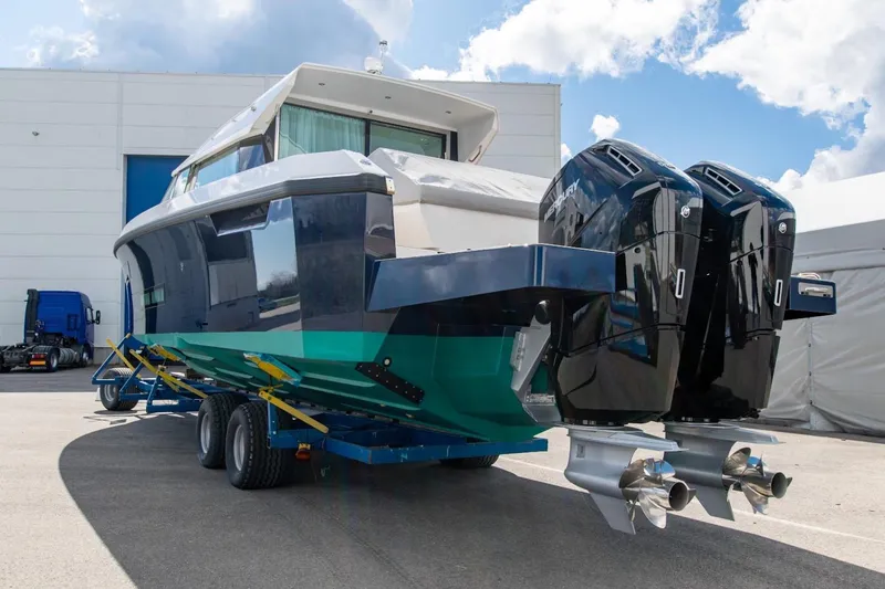  Yacht Photos Pics 2026 Delta Powerboats 48 Coupe on trailer, featuring dual outboard engines, parked outdoors.