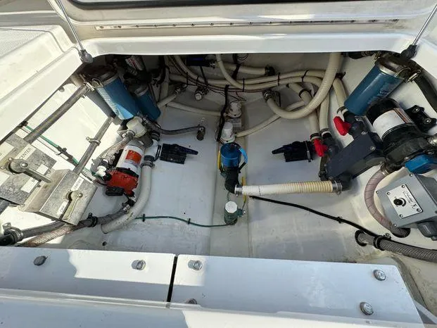 Killin Time II Yacht Photos Pics Engine compartment of a 2015 Invincible 39 Open Fisherman boat, showcasing various mechanical components.