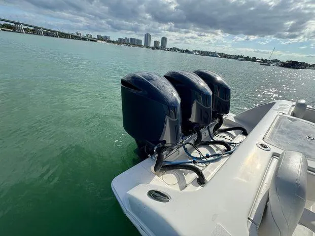 Killin Time II Yacht Photos Pics 2015 Invincible 39 Open Fisherman boat with triple outboard engines on calm water.