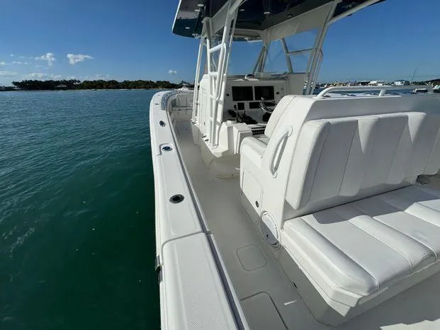 Killin Time II Yacht Photos Pics 2015 Invincible 39 Open Fisherman boat on calm water, showcasing sleek design and seating.