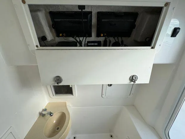 Killin Time II Yacht Photos Pics 2015 Invincible 39 Open Fisherman boat interior with sink and storage compartments.