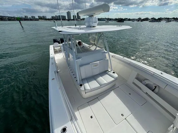Killin Time II Yacht Photos Pics 2015 Invincible 39 Open Fisherman boat on water, spacious deck, city skyline in background.