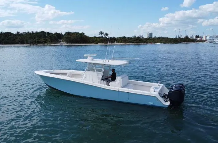 Killin Time II Yacht Photos Pics 2015 Invincible 39 Open Fisherman boat on calm water, clear sky background.