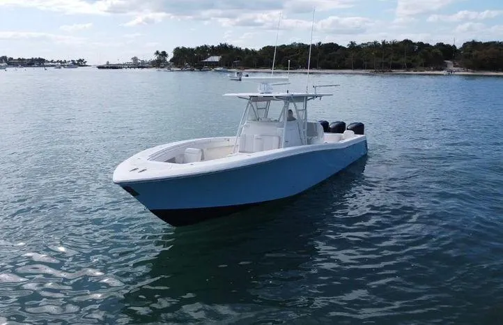 Killin Time II Yacht Photos Pics 2015 Invincible 39 Open Fisherman boat on calm water, distant shoreline in background.