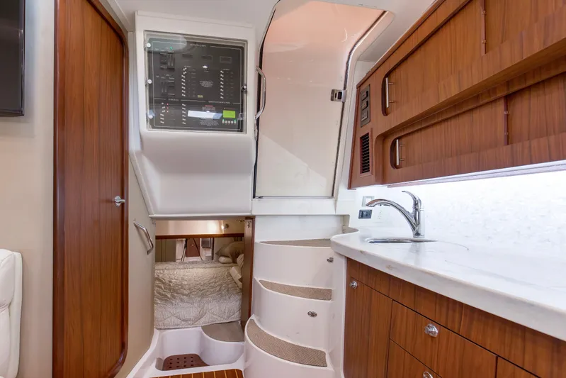 Papa's Dream Yacht Photos Pics Interior of 2016 Grady-White Express 370 boat with wood cabinetry and compact kitchen.