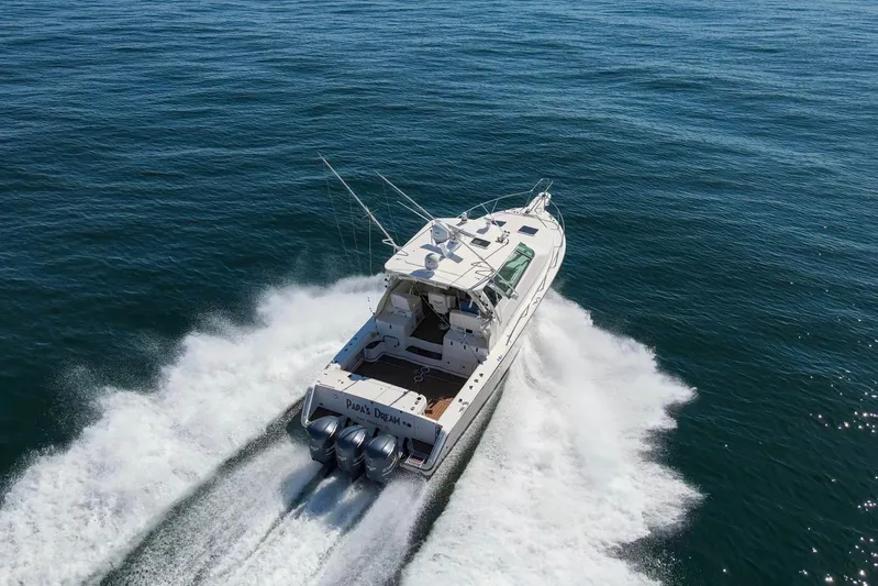 Papa's Dream Yacht Photos Pics 2016 Grady-White Express 370 cruising on open water, rear view, creating a wake.