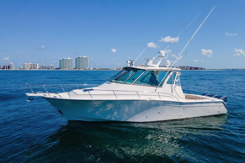 Papa's Dream Yacht Photos Pics 2016 Grady-White Express 370 boat on calm ocean with city skyline in background.