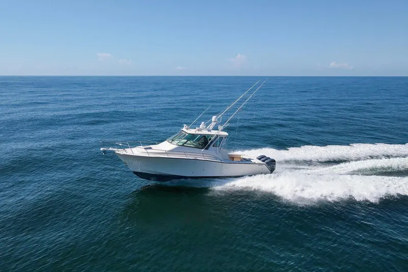 Papa's Dream Yacht Photos Pics 2016 Grady-White Express 370 cruising on open ocean under clear blue sky.