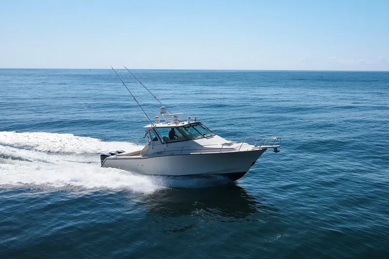 Papa's Dream Yacht Photos Pics 2016 Grady-White Express 370 cruising on open ocean under clear blue sky.