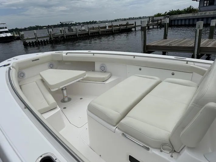 43 Everglades 435 Cc Yacht Photos Pics 2017 Everglades 435 Center Console boat with white seating, docked by a marina.