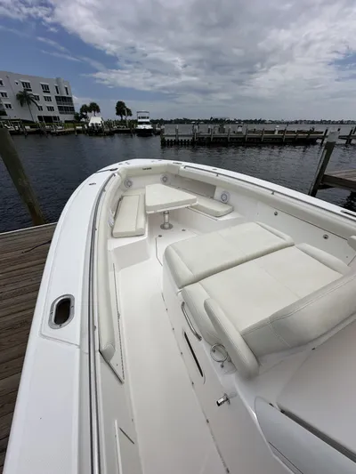 43 Everglades 435 Cc Yacht Photos Pics 2017 Everglades 435 Center Console boat docked by the waterfront under cloudy skies.