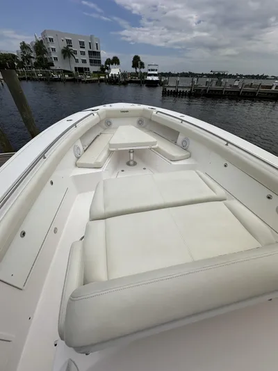 43 Everglades 435 Cc Yacht Photos Pics 2017 Everglades 435 Center Console boat with white seating, docked by a waterfront.