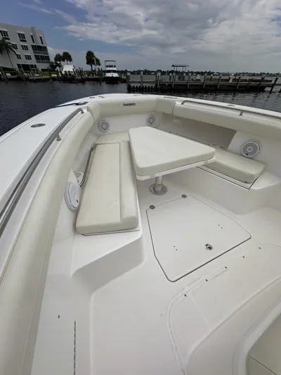 43 Everglades 435 Cc Yacht Photos Pics 2017 Everglades 435 Center Console boat with spacious seating and table, docked by the waterfront.
