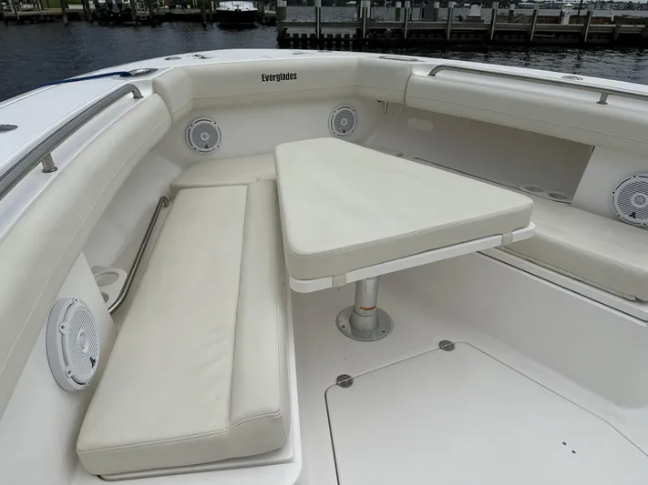43 Everglades 435 Cc Yacht Photos Pics 2017 Everglades 435 Center Console boat with cushioned seating and table, docked at marina.