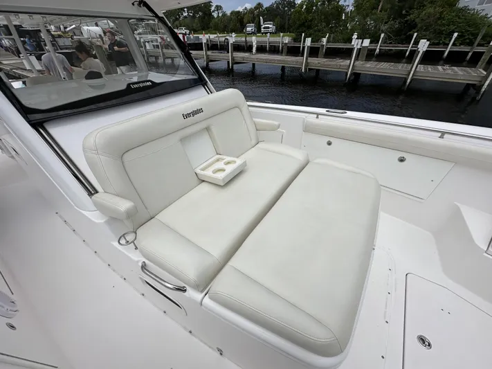 43 Everglades 435 Cc Yacht Photos Pics 2017 Everglades 435 Center Console boat with white seating and cup holders, docked by the water.