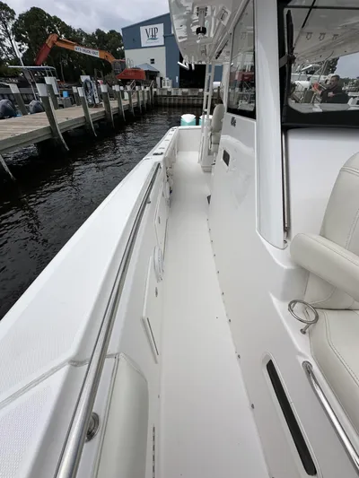 43 Everglades 435 Cc Yacht Photos Pics 2017 Everglades 435 Center Console boat docked at marina, showcasing sleek white deck design.