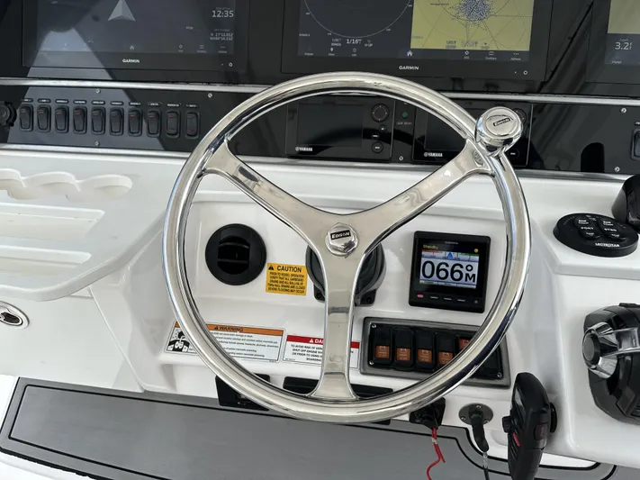 43 Everglades 435 Cc Yacht Photos Pics Steering wheel of a 2017 Everglades 435 Center Console boat with navigation displays.