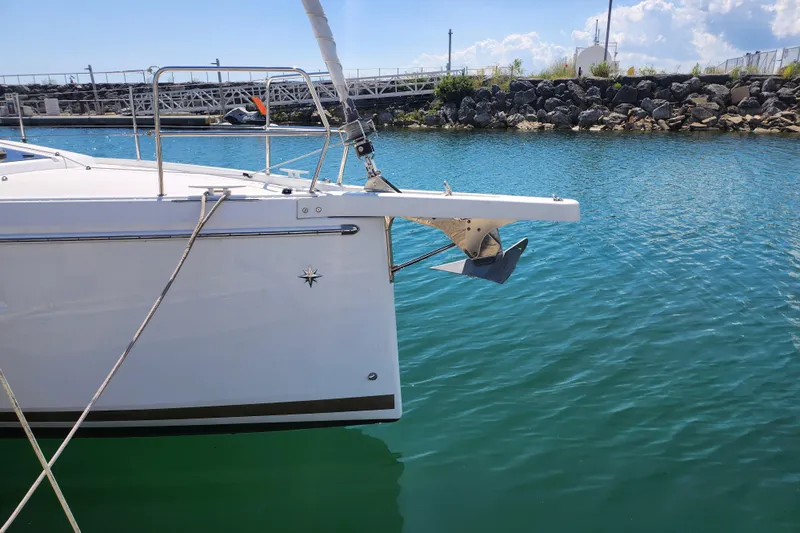 Rondeau Yacht Photos Pics Jeanneau Sun Odyssey 410 sailboat, 2020 model, docked in a marina with clear blue water.