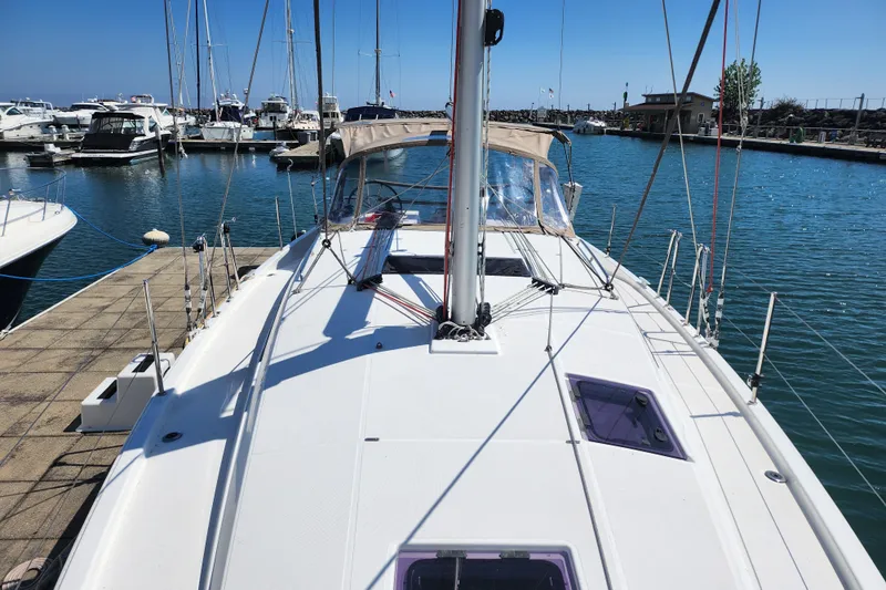 Rondeau Yacht Photos Pics 2020 Jeanneau Sun Odyssey 410 sailboat docked in a marina under clear blue skies.