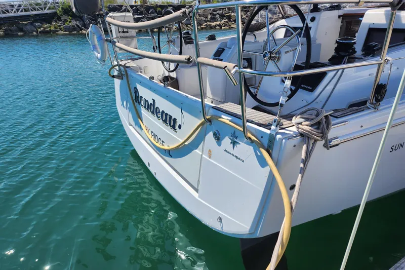 Rondeau Yacht Photos Pics Jeanneau Sun Odyssey 410 sailboat docked, showcasing steering wheel and deck details.