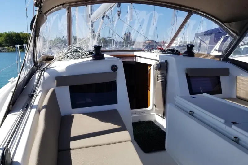 Rondeau Yacht Photos Pics 2020 Jeanneau Sun Odyssey 410 cockpit with seating and winches, docked in a marina.