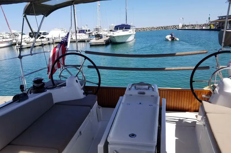 Rondeau Yacht Photos Pics Jeanneau Sun Odyssey 410 sailboat, 2020 model, docked in a marina with clear blue water.