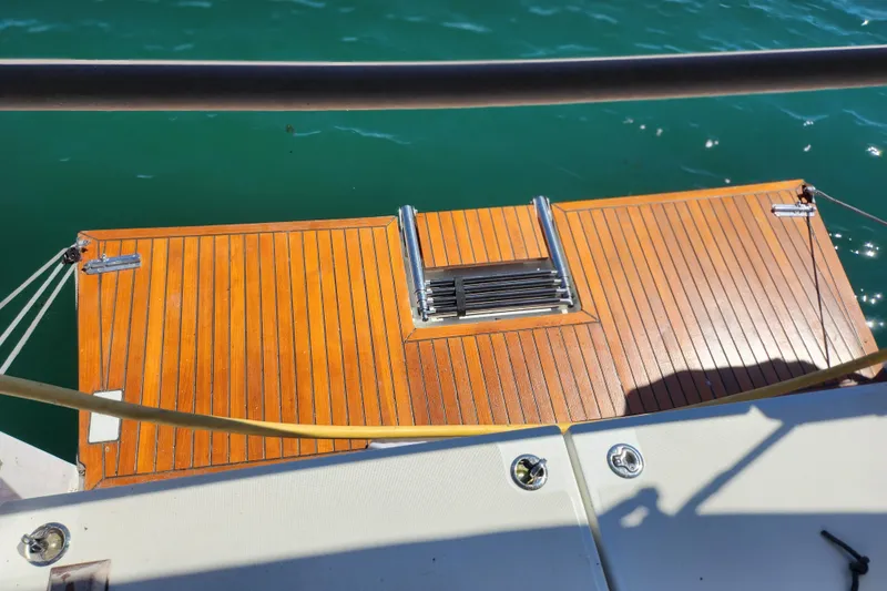 Rondeau Yacht Photos Pics Jeanneau Sun Odyssey 410, 2020 model, featuring a wooden swim platform and ladder.