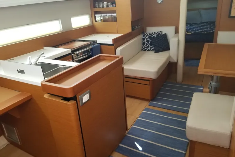 Rondeau Yacht Photos Pics Interior of 2020 Jeanneau Sun Odyssey 410 yacht with modern kitchen and seating area.