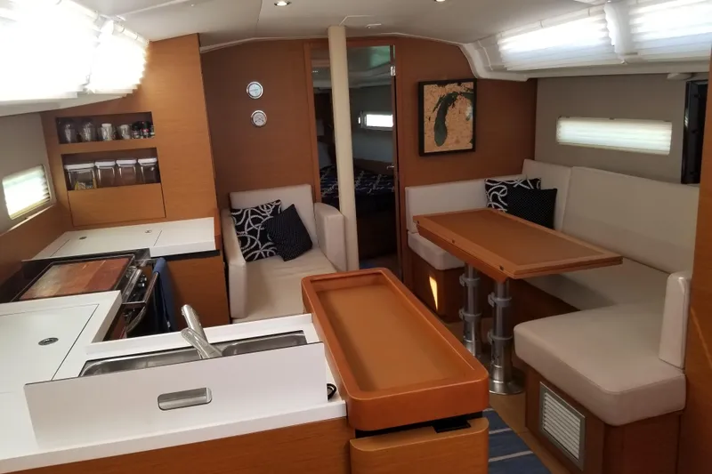 Rondeau Yacht Photos Pics Interior of 2020 Jeanneau Sun Odyssey 410 yacht with modern kitchen and seating area.