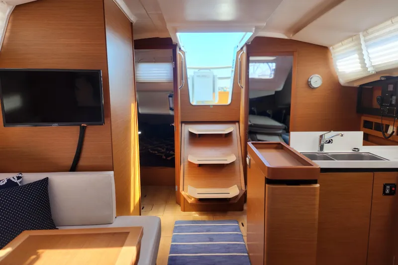 Rondeau Yacht Photos Pics Interior of 2020 Jeanneau Sun Odyssey 410 yacht with modern kitchen and seating area.