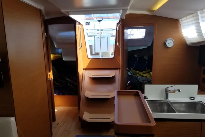 Rondeau Yacht Photos Pics Interior of 2020 Jeanneau Sun Odyssey 410 sailboat with wooden finish and modern kitchen.