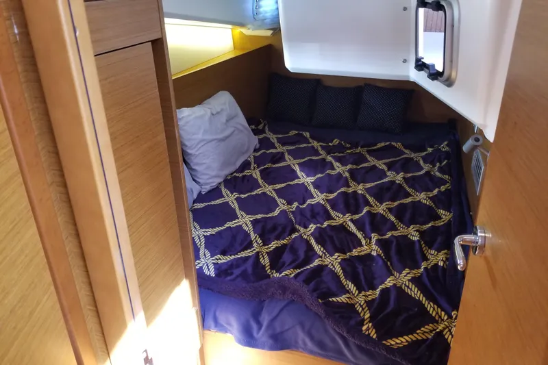 Rondeau Yacht Photos Pics Cozy cabin interior of 2020 Jeanneau Sun Odyssey 410 sailboat with nautical bedding.