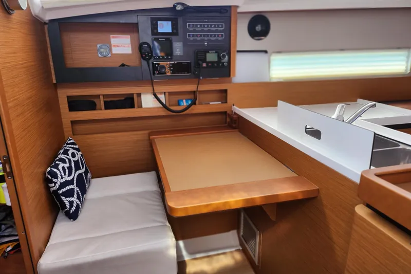 Rondeau Yacht Photos Pics Interior of 2020 Jeanneau Sun Odyssey 410 yacht with navigation station and seating area.