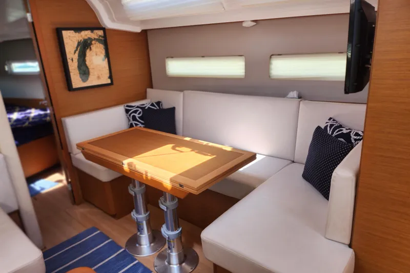 Rondeau Yacht Photos Pics Interior of 2020 Jeanneau Sun Odyssey 410 yacht with cozy seating and table.