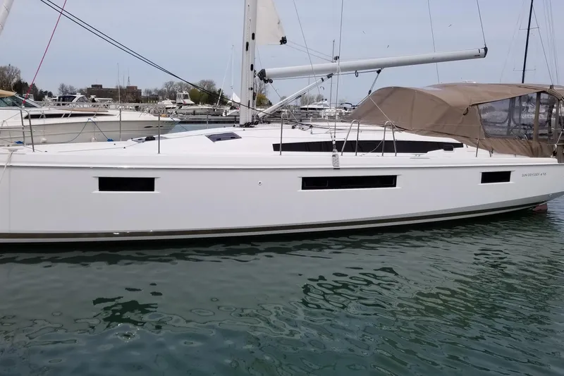 Rondeau Yacht Photos Pics 2020 Jeanneau Sun Odyssey 410 sailboat docked in a marina, side view.