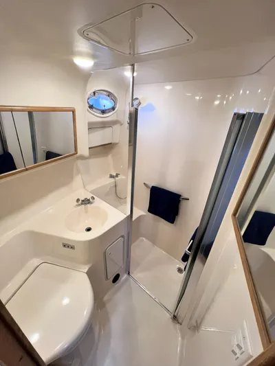 Rising Tide Yacht Photos Pics Bathroom interior of 1996 Sea Ray 400 Sedan Bridge yacht, featuring shower and sink.