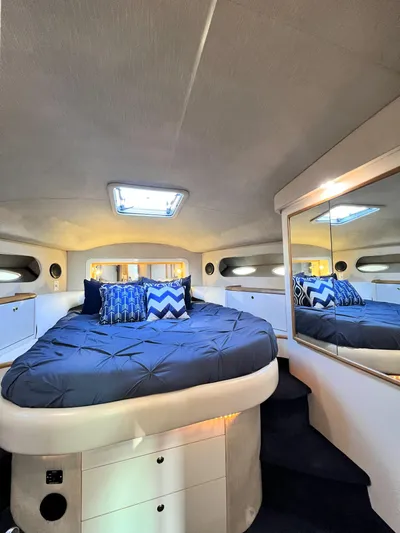Rising Tide Yacht Photos Pics Luxurious 1996 Sea Ray 400 Sedan Bridge cabin with cozy bed and stylish decor.