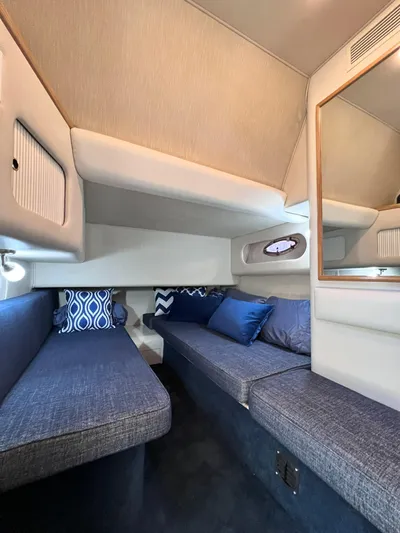 Rising Tide Yacht Photos Pics Interior of 1996 Sea Ray 400 Sedan Bridge with blue seating and decorative pillows.