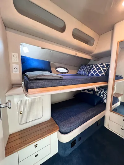 Rising Tide Yacht Photos Pics Interior of 1996 Sea Ray 400 Sedan Bridge with cozy bunk beds and nautical decor.