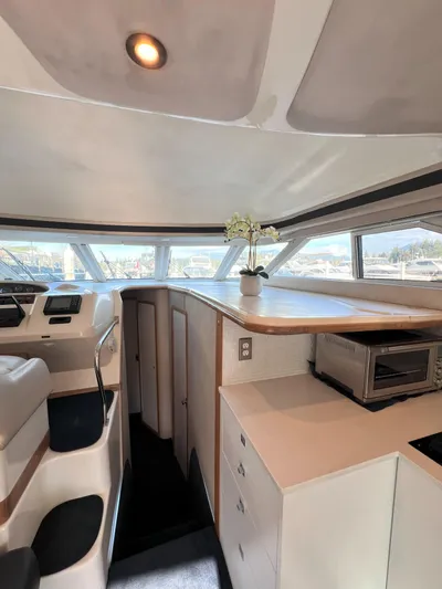 Rising Tide Yacht Photos Pics Interior of 1996 Sea Ray 400 Sedan Bridge yacht with modern kitchen and seating area.