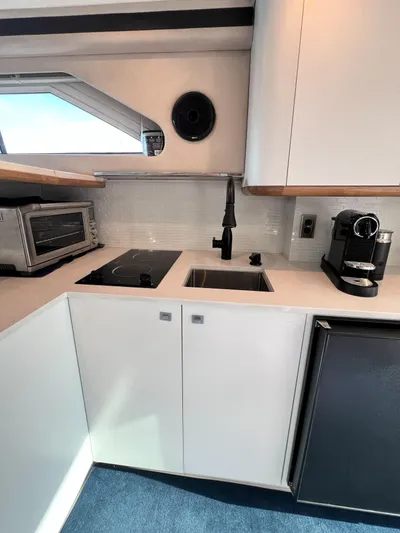 Rising Tide Yacht Photos Pics 1996 Sea Ray 400 Sedan Bridge kitchen with modern appliances and sleek cabinetry.