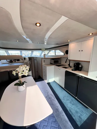 Rising Tide Yacht Photos Pics Interior of 1996 Sea Ray 400 Sedan Bridge yacht with modern kitchen and dining area.