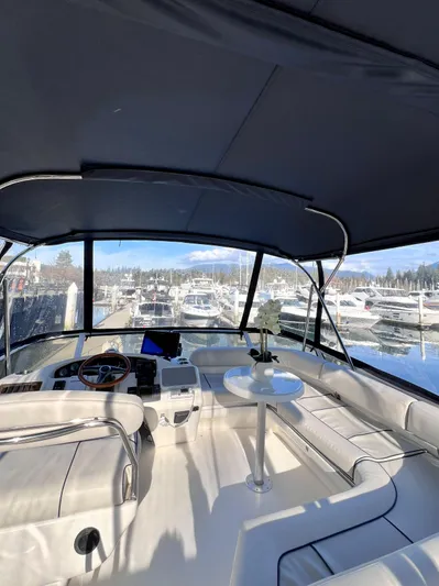 Rising Tide Yacht Photos Pics 1996 Sea Ray 400 Sedan Bridge interior with marina view, featuring helm and seating area.