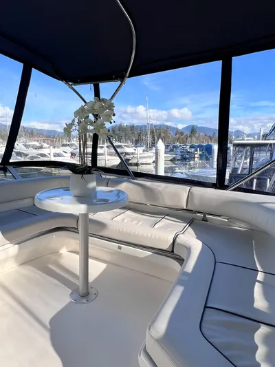 Rising Tide Yacht Photos Pics Interior view of 1996 Sea Ray 400 Sedan Bridge yacht with seating and table.