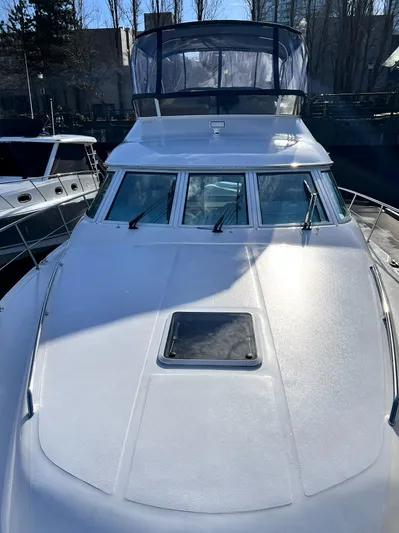 Rising Tide Yacht Photos Pics 1996 Sea Ray 400 Sedan Bridge yacht with sleek design and spacious deck.