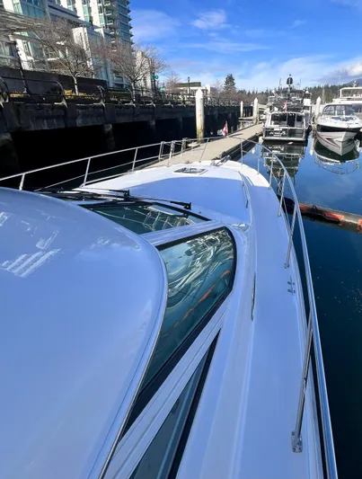 Rising Tide Yacht Photos Pics 1996 Sea Ray 400 Sedan Bridge docked at marina under clear blue sky.