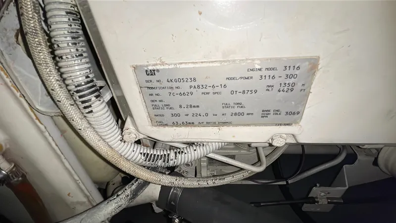 Rising Tide Yacht Photos Pics Engine compartment of 1996 Sea Ray 400 Sedan Bridge with CAT 3116 engine label.